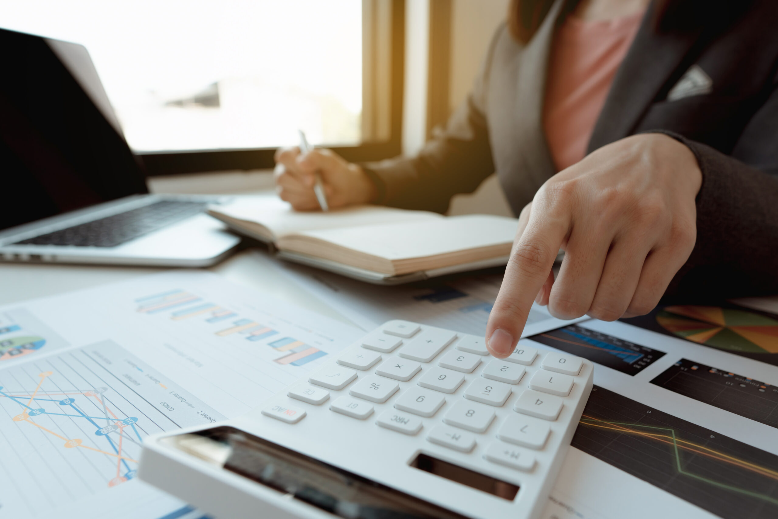 Businessmen,Use,A,Calculator,To,Calculate,Income,And,Expenses,In